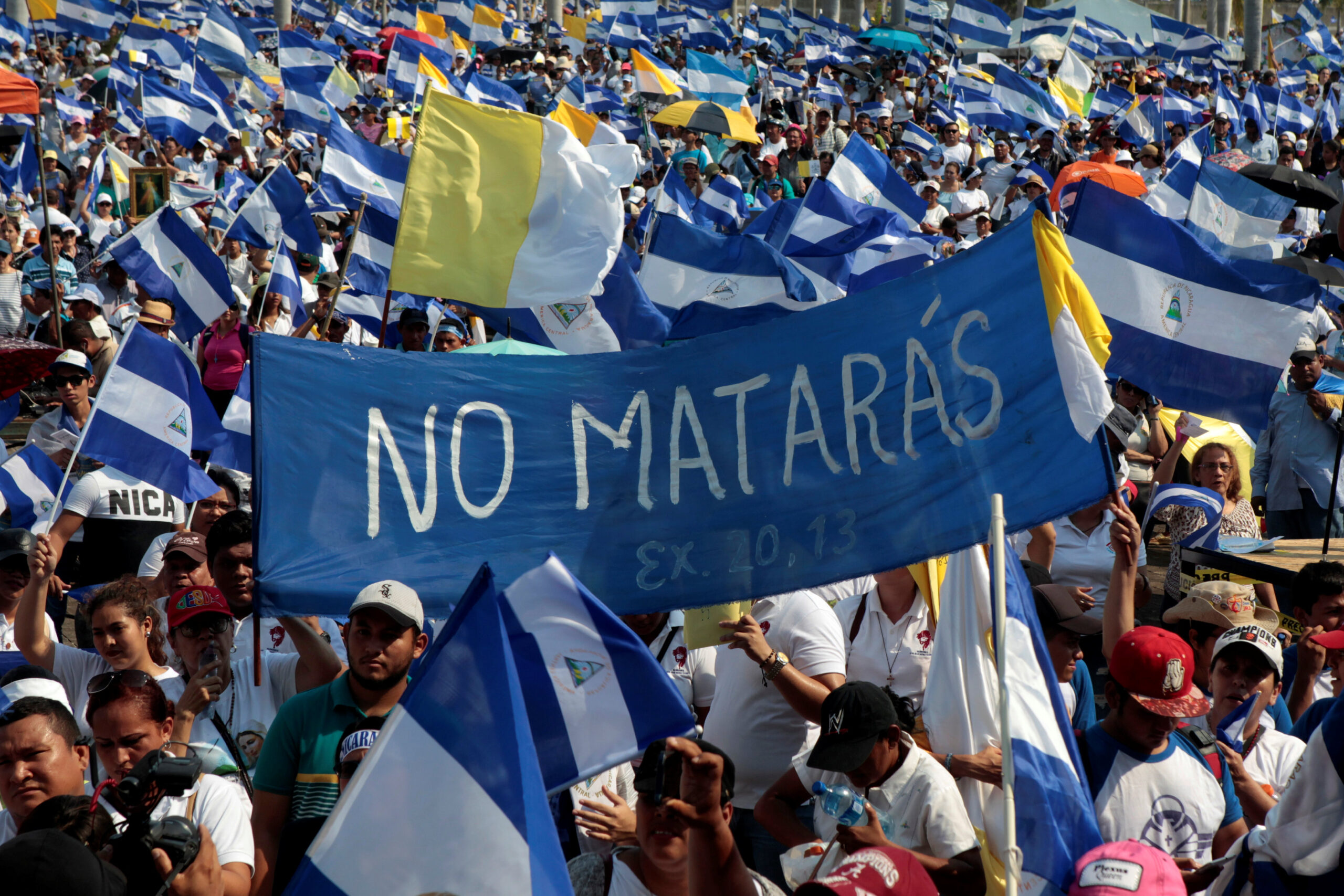 People take part in a protest march to demand an end to violence in Managua